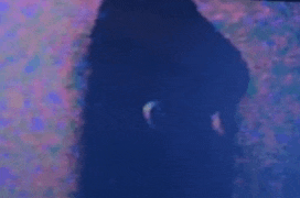 a blurry picture of a person 's face in a dark room