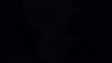 a close up of a person 's face in a dark room with a blue background .