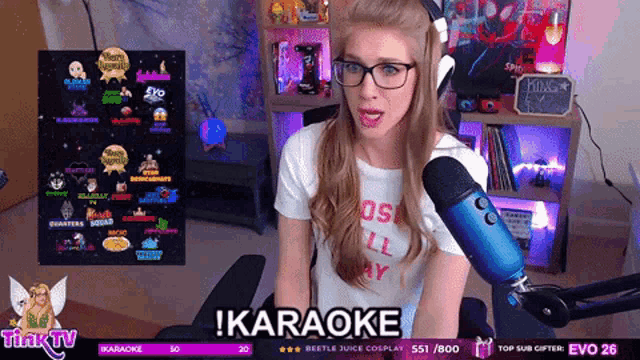 a woman sitting in front of a blue microphone with karaoke written on the screen behind her