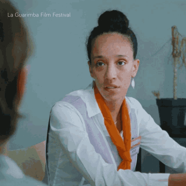 a woman sitting at a table with the words la guarimba film festival on the bottom of the image