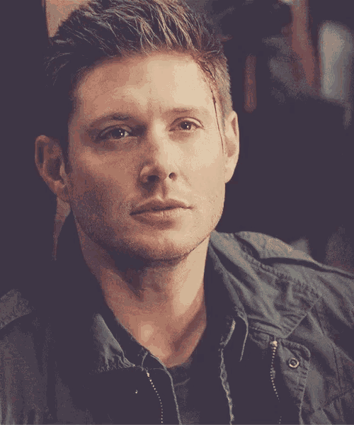 a close up of a man wearing a black jacket