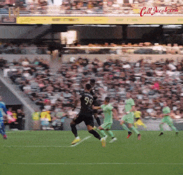 a soccer player with the number 96 on his back kicks the ball