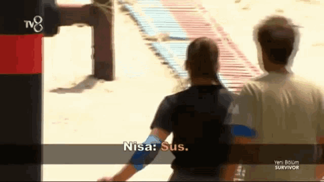 a man and a woman are standing next to each other with the words nisa sus on the screen