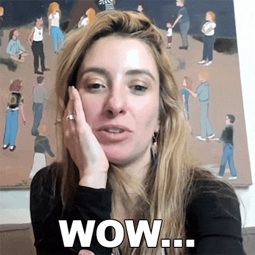 a woman says wow in front of a crowd of people