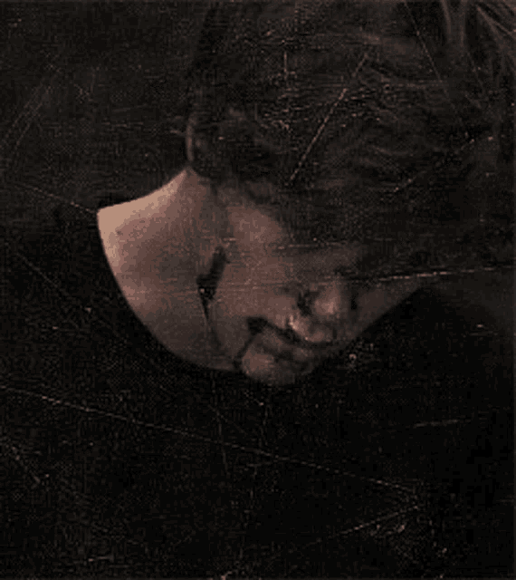 a man with blood on his face looks at the camera