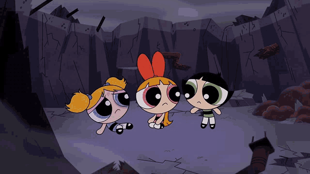 three cartoon characters are sitting on the ground in front of a rock wall