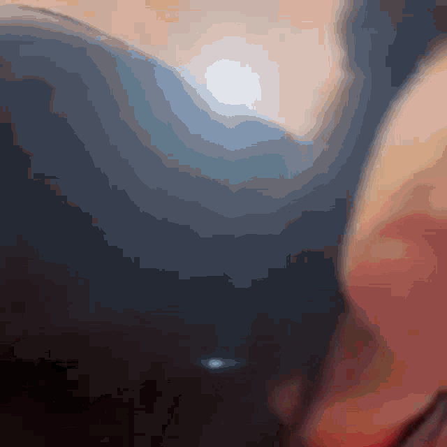 a blurry image of a person 's face with a blue background