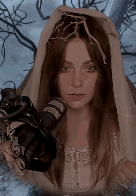 a woman in a white veil is holding a camera