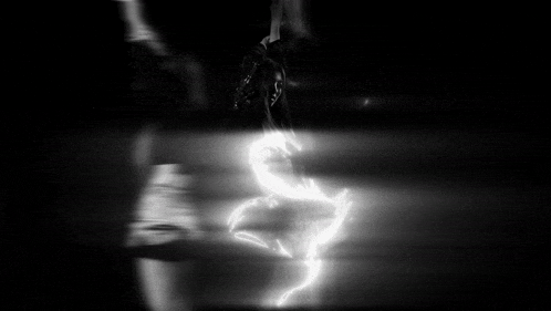 a blurry picture of a person standing in front of a glass door .