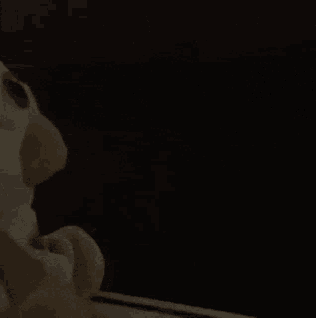 a black background with a white object in the corner