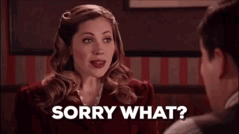 a woman is talking to a man in a restaurant and says `` sorry what '' .