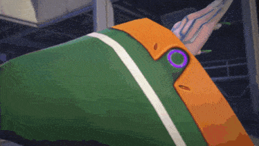 a green and orange item with a purple circle on the side