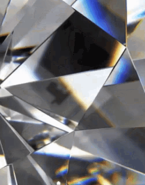 a close up of a diamond with a rainbow colored reflection