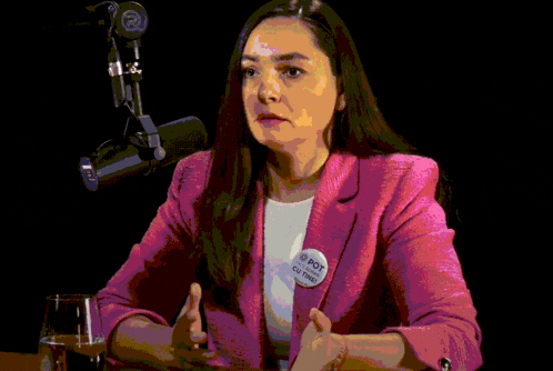 a woman in a pink jacket says whatever