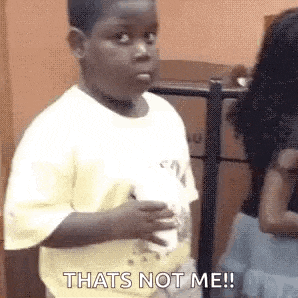 a young boy is holding a cup of coffee and saying `` that 's not me '' .