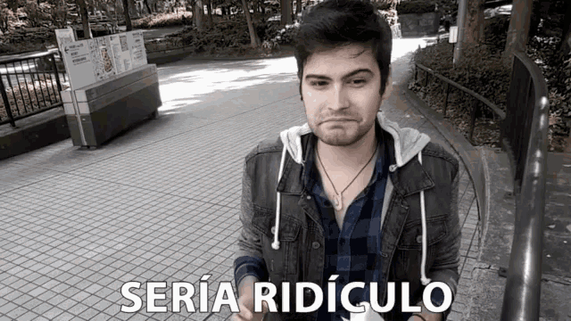 a man in a plaid shirt stands in front of a sign that says seria ridiculo on it