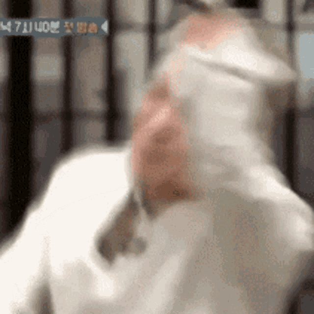 a blurry image of a man with a bandage on his head
