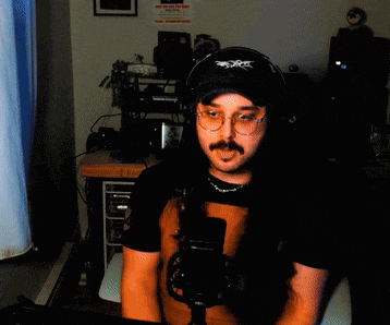 a man wearing headphones and a hat with the word x on it
