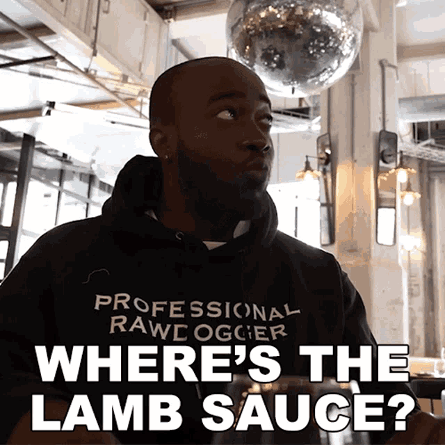 a man wearing a black hoodie that says professional raw ogcer where 's the lamb sauce