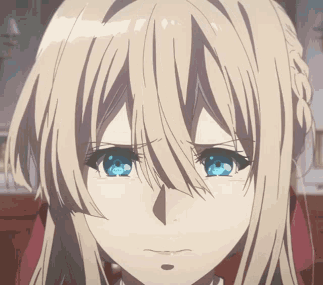 a close up of a girl 's face with blue eyes
