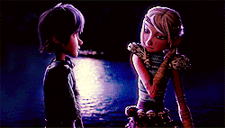 a boy and a girl from how to train your dragon are standing next to each other .