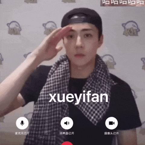 a man wearing a hat and scarf salutes with the name xueyifan written on the screen