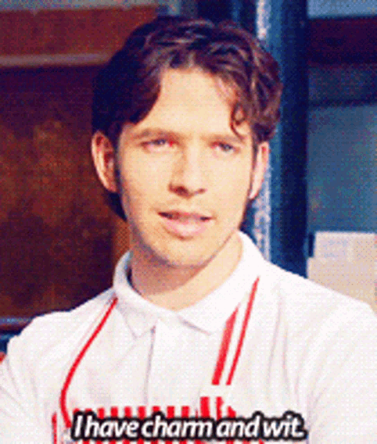a man wearing a white shirt that says i have charm and wit on it