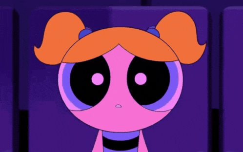 bubbles from the powerpuff girls is sitting in a theater with a heart in her eyes .