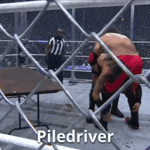 a wrestling match is going on behind a chain link fence and the referee is standing behind it .