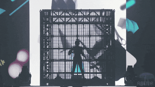 a silhouette of a person standing in front of a screen that says abema on it