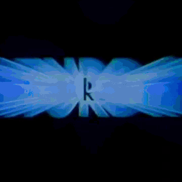 a close up of a blue glowing logo on a black background .