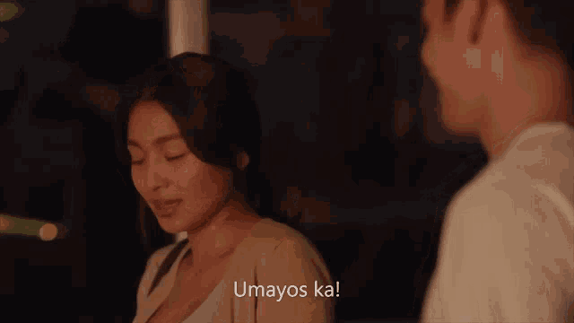 a man and a woman are looking at each other and the woman says umayos ka