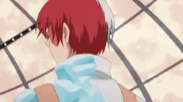 a close up of a person 's back with red hair and a blue shirt .
