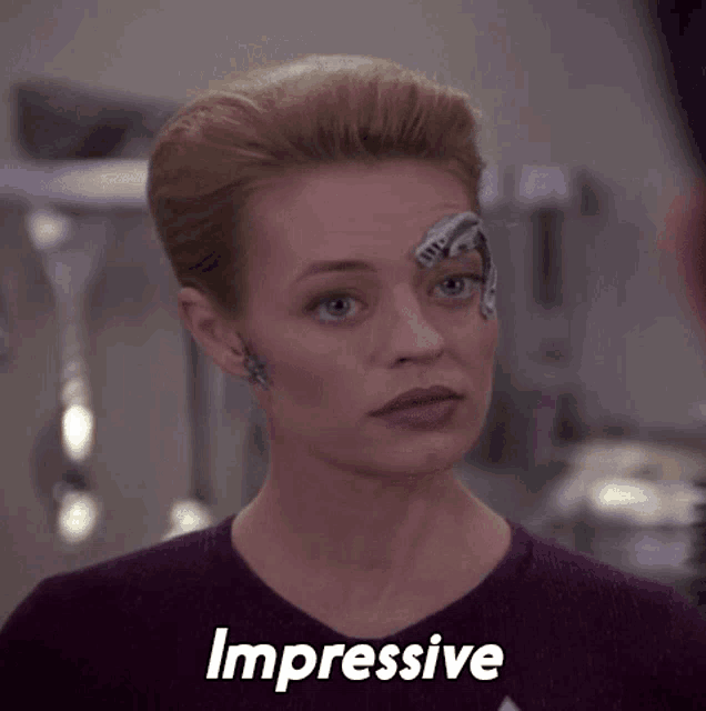 a woman with a robot on her forehead has the word impressive above her head