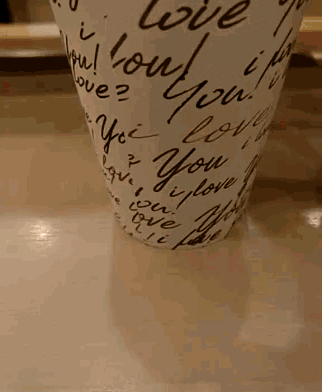a cup that says i love you is on a table