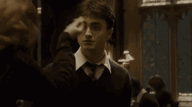 harry potter and hermione granger are talking to each other in a dark room