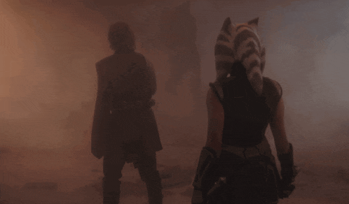 a man and a woman are standing in a foggy room