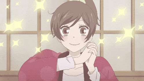 a girl in a ponytail is smiling and holding her hand to her chest