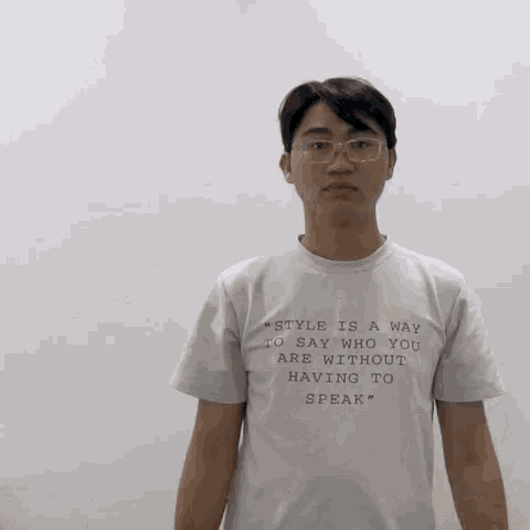 a man wearing a white shirt that says " style is a way to say who you are without having to speak " on it