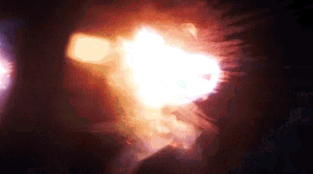 a close up of a fireball exploding in the dark