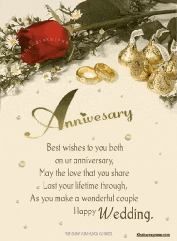 a wedding anniversary card with rings and flowers