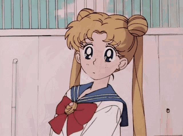 a girl in a sailor suit has a red bow on her bowtie