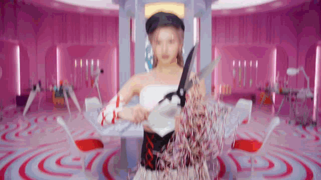 a woman in a white dress is holding a pair of scissors in her hands .