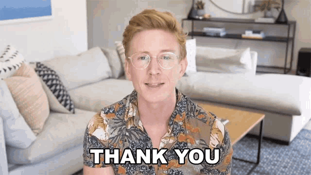 a man in a living room says thank you