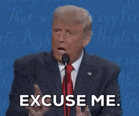 a man in a suit and tie is giving a speech and says " excuse me "