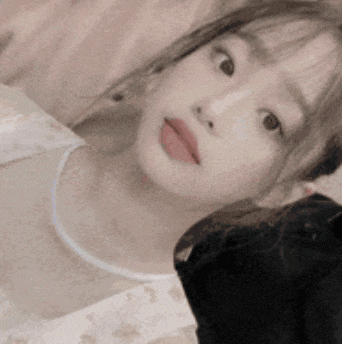 a close up of a woman taking a selfie with a black cat .