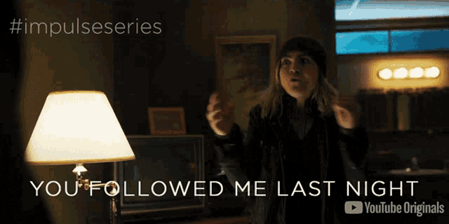 a woman standing in front of a lamp with the words you followed me last night
