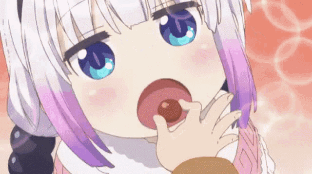 a girl with purple hair and blue eyes is eating a donut from her hand .