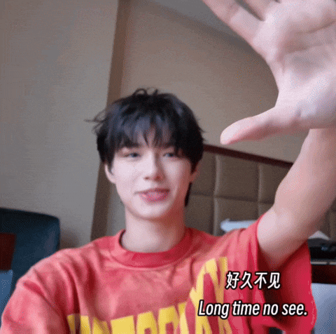 a person wearing a red shirt that says long time no see on it