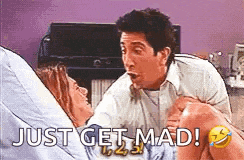 a man is standing next to a woman in a hospital bed and says `` just get mad '' .
